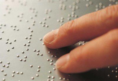dita leggono testo in braille
